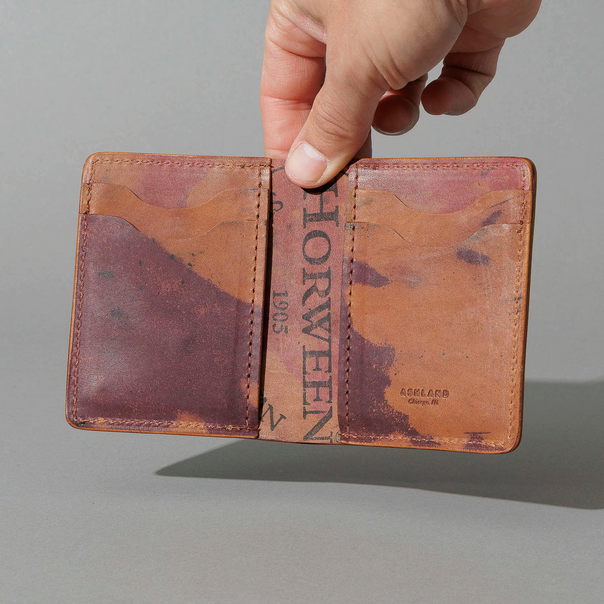 One-Off Tall Vertical Tony in Hand-Glazed Reverse Color 8 Shell Cordovan, held open in hand, shot 1