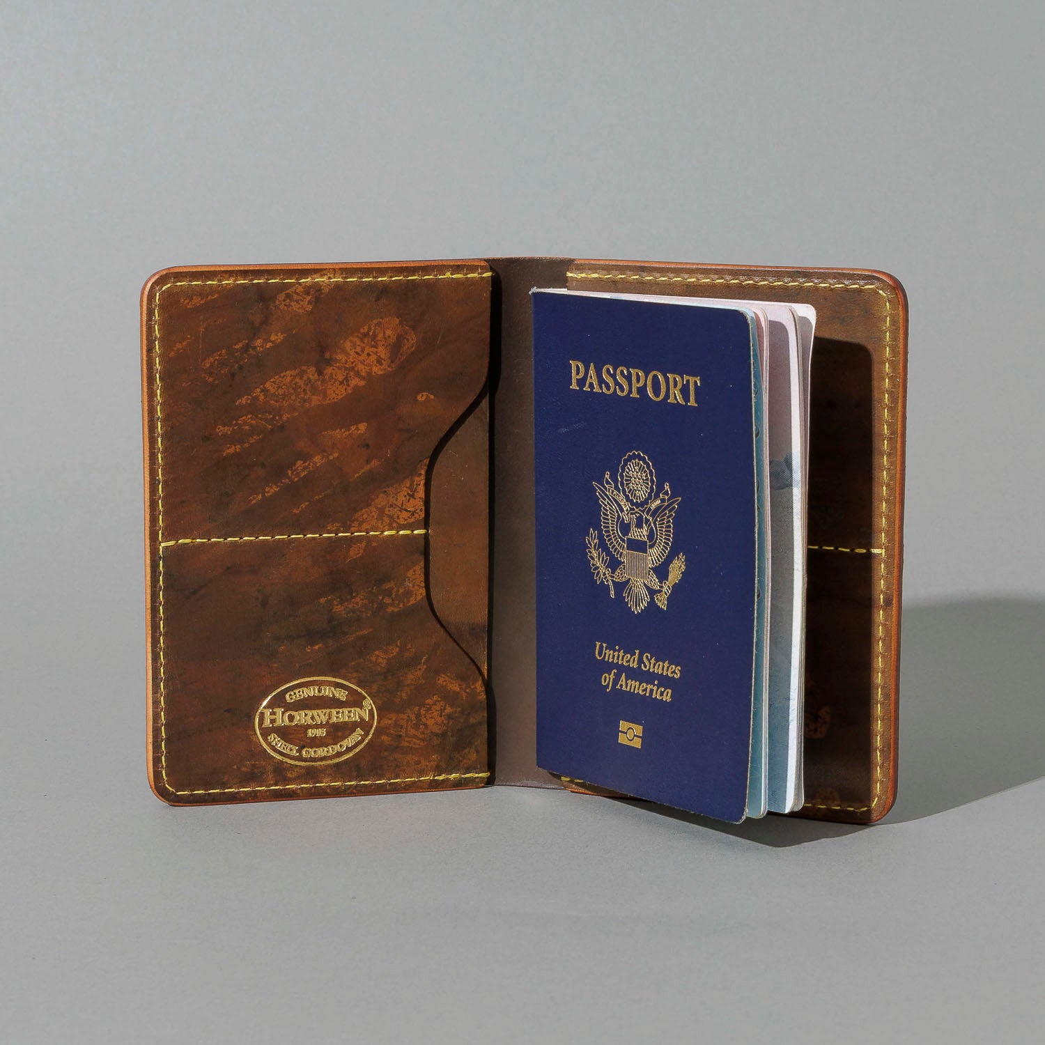 One-Off Traveler Passport Holder in Epic Splatter Reverse Cigar Shell Cordovan, No Bill Slot, open with a passport inside