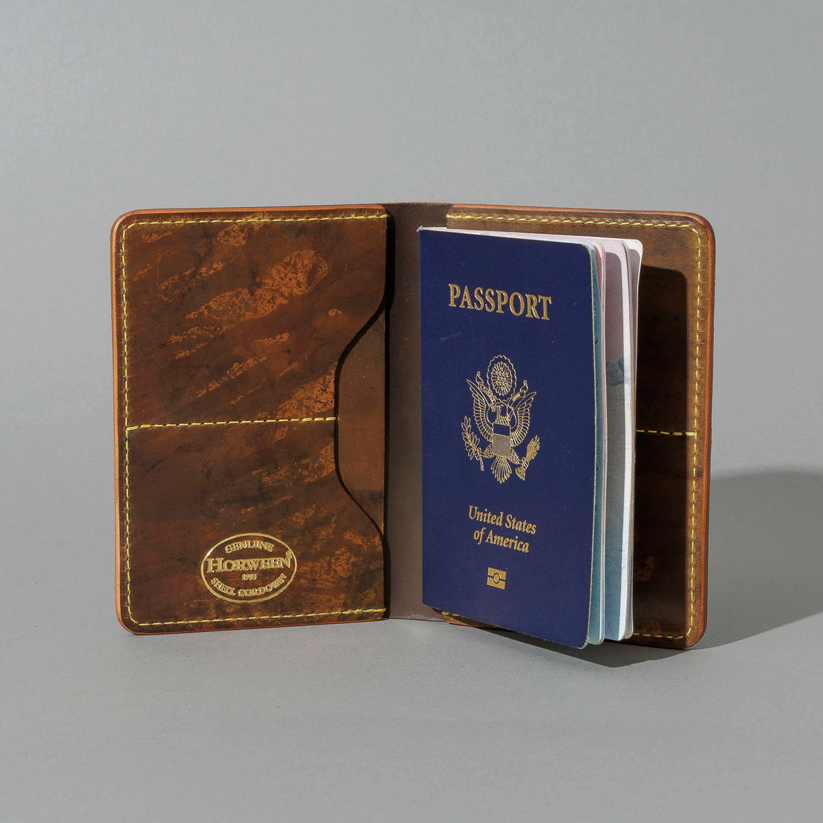 One-Off Traveler Passport Holder in Epic Splatter Reverse Cigar Shell Cordovan, No Bill Slot, open with a passport inside