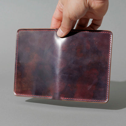 One-Off Traveler Passport Holder in Psychedelic Color 8 Shell Cordovan, No Bill Slot, held open in hand, shot 1