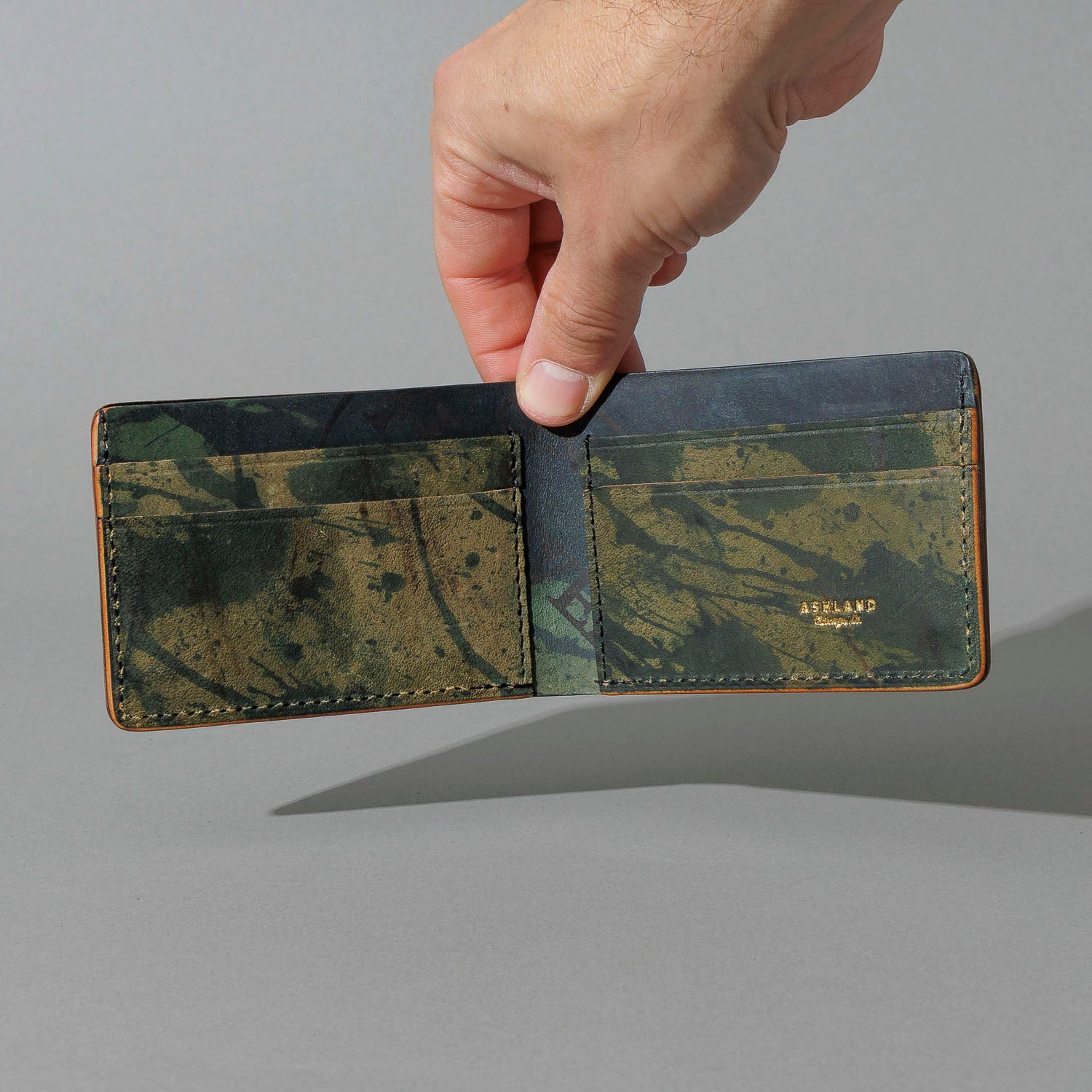 One-Off Nicky Slim in Reverse Green Shell Cordovan, held open in hand