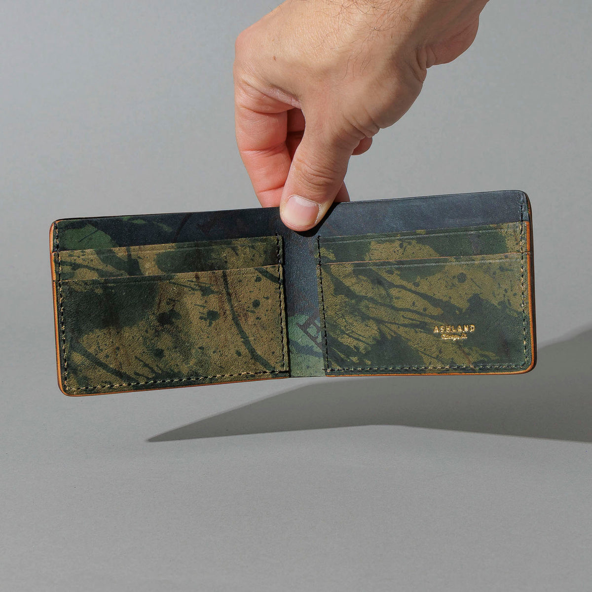 One-Off Nicky Slim in Reverse Green Shell Cordovan, held open in hand