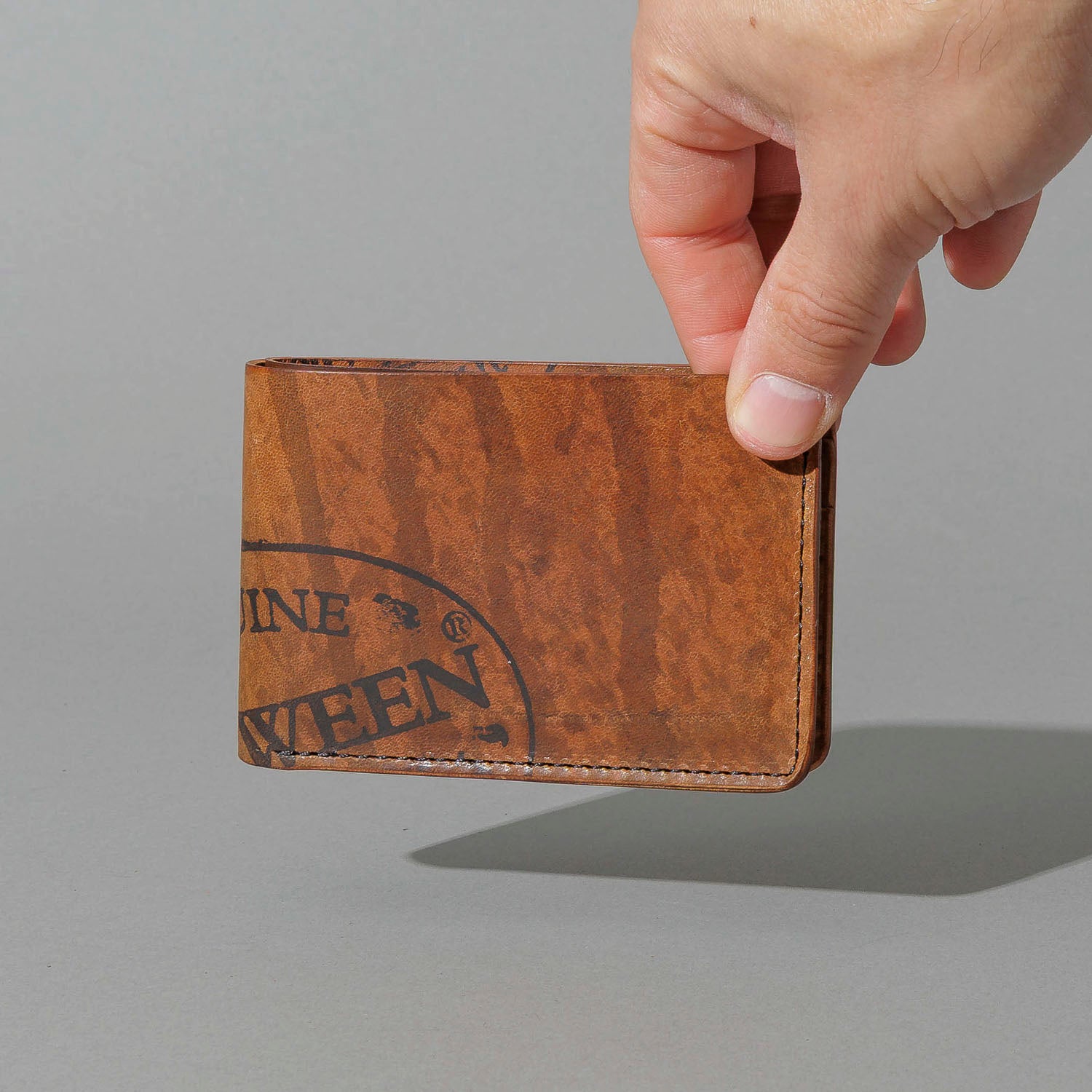 One-Off Nicky Slim in Hand-Glazed Reverse Epic Splatter Cigar Shell Cordovan, held in hand
