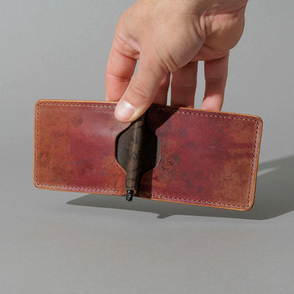 One-Off Capone Money Clip in Hand-Glazed Reverse Shell Cordovan, held open in hand, shot 1
