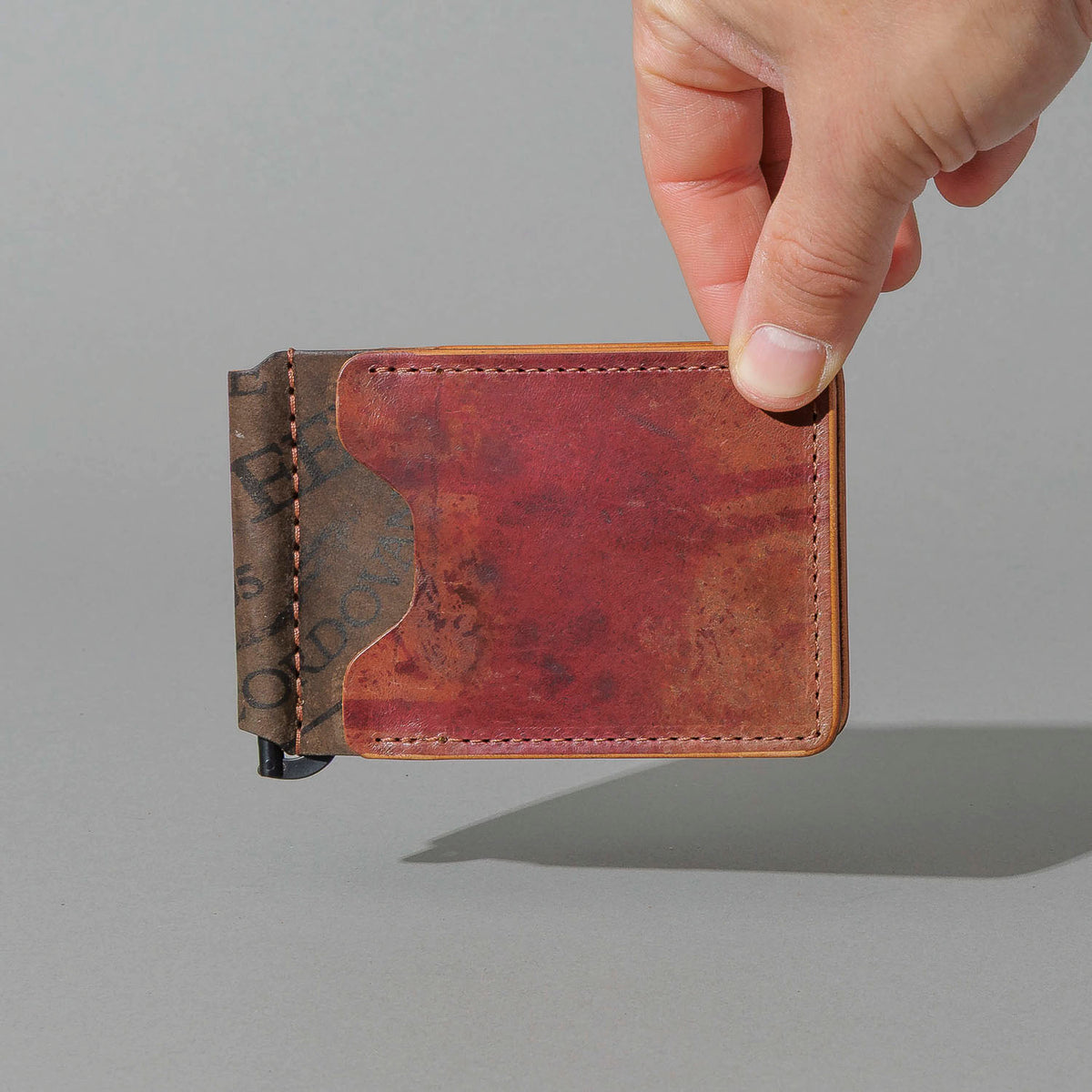 One-Off Capone Money Clip in Hand-Glazed Reverse Shell Cordovan, held in hand, shot 1