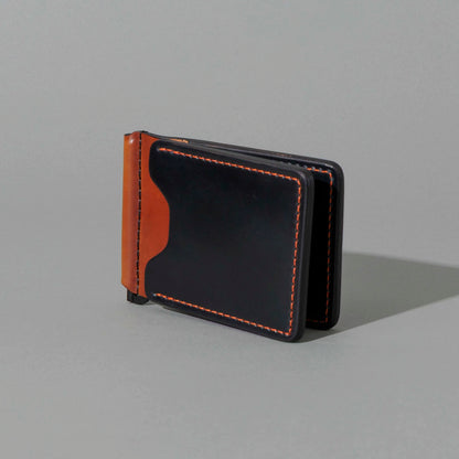 One-Off Capone Money Clip in Black on Blood Orange Shell Cordovan, standing upright, side angle