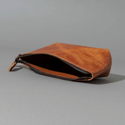 One-Off Prototype Pouch in Hammered Olive Tanned, angled view lying flat, shot 3