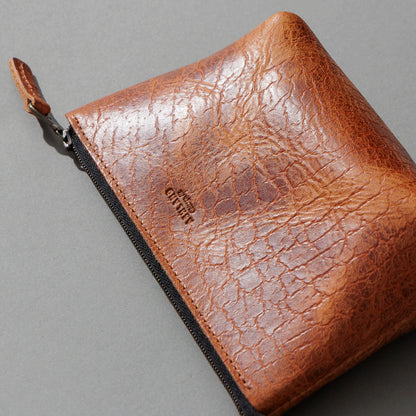 One-Off Prototype Pouch in Hammered Olive Tanned, angled view lying flat, shot 1
