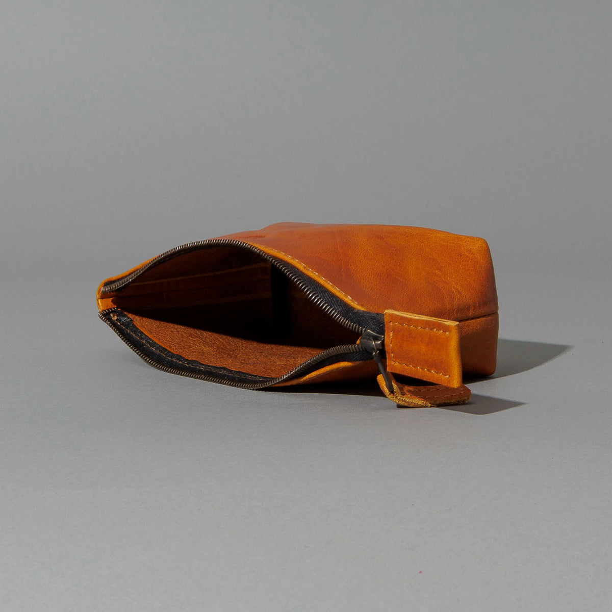 One-Off Prototype Pouch in Acorn Aspen Horsehide, angled view lying flat, shot 2