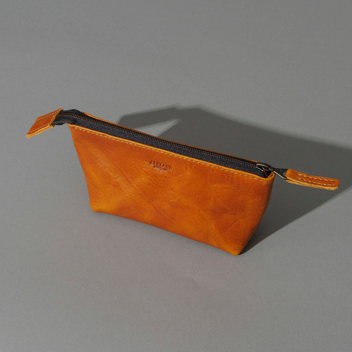 One-Off Prototype Pouch in Acorn Aspen Horsehide, angled view lying flat, shot 3