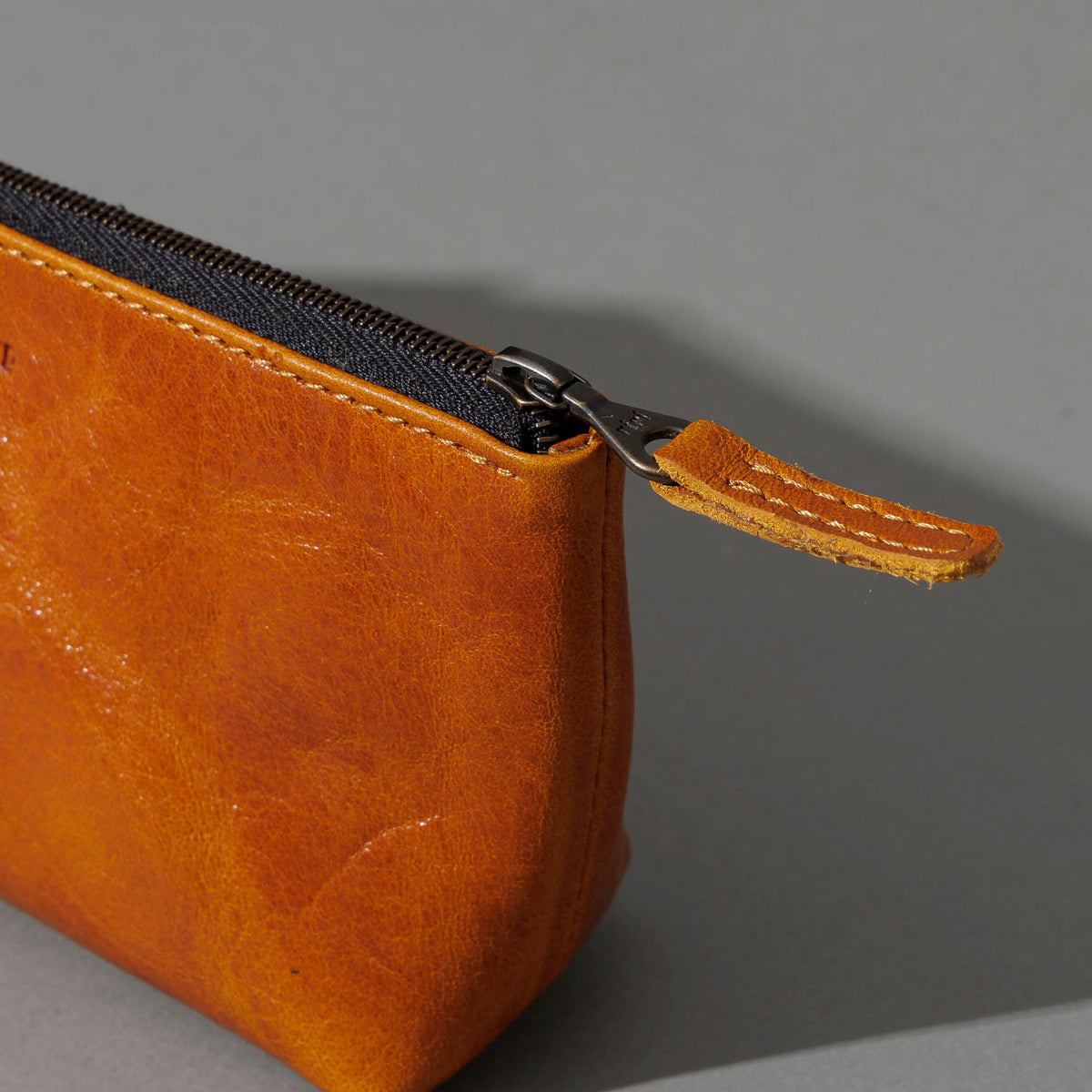 One-Off Prototype Pouch in Acorn Aspen Horsehide, angled view lying flat, shot 4