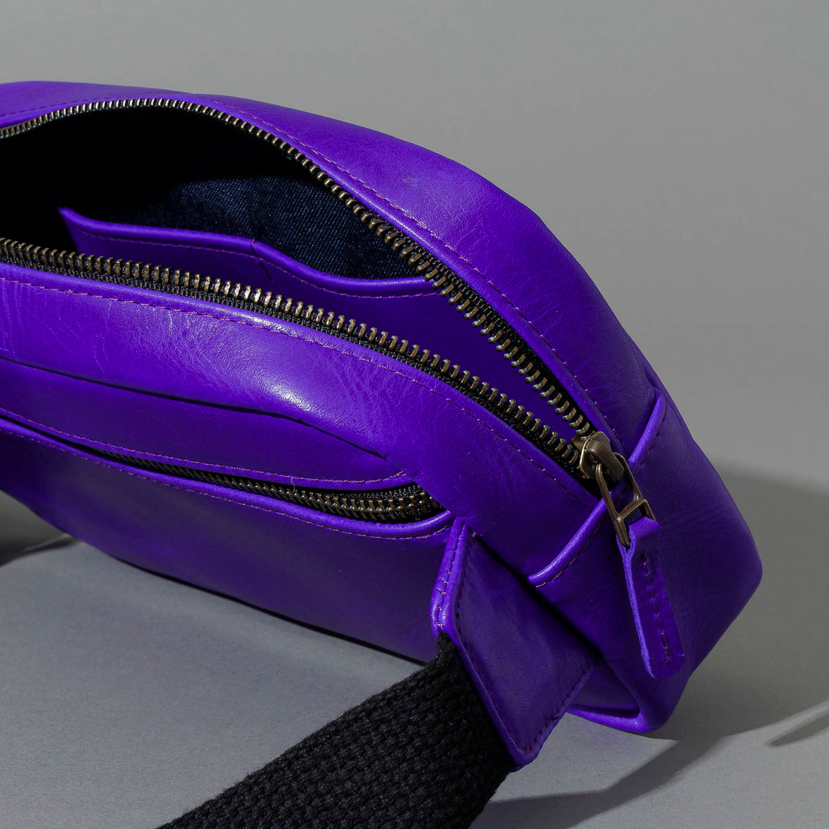 One-Off Sling Bag in Violet Latigo, angled view lying flat, shot 4