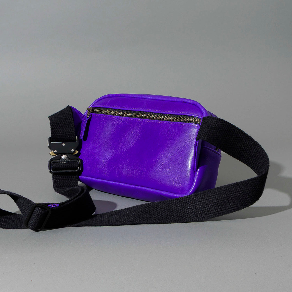 One-Off Sling Bag in Violet Latigo, angled view lying flat, shot 3