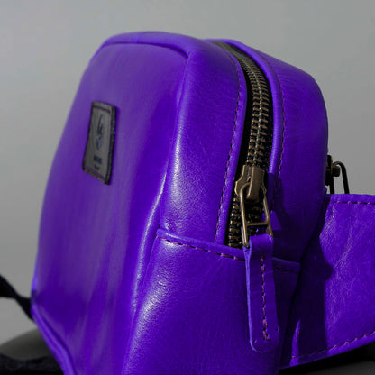One-Off Sling Bag in Violet Latigo, angled view lying flat, shot 1