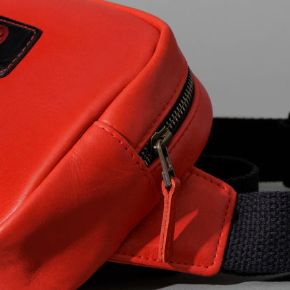 One-Off Sling Bag in Red Latigo, angled view lying flat, shot 1