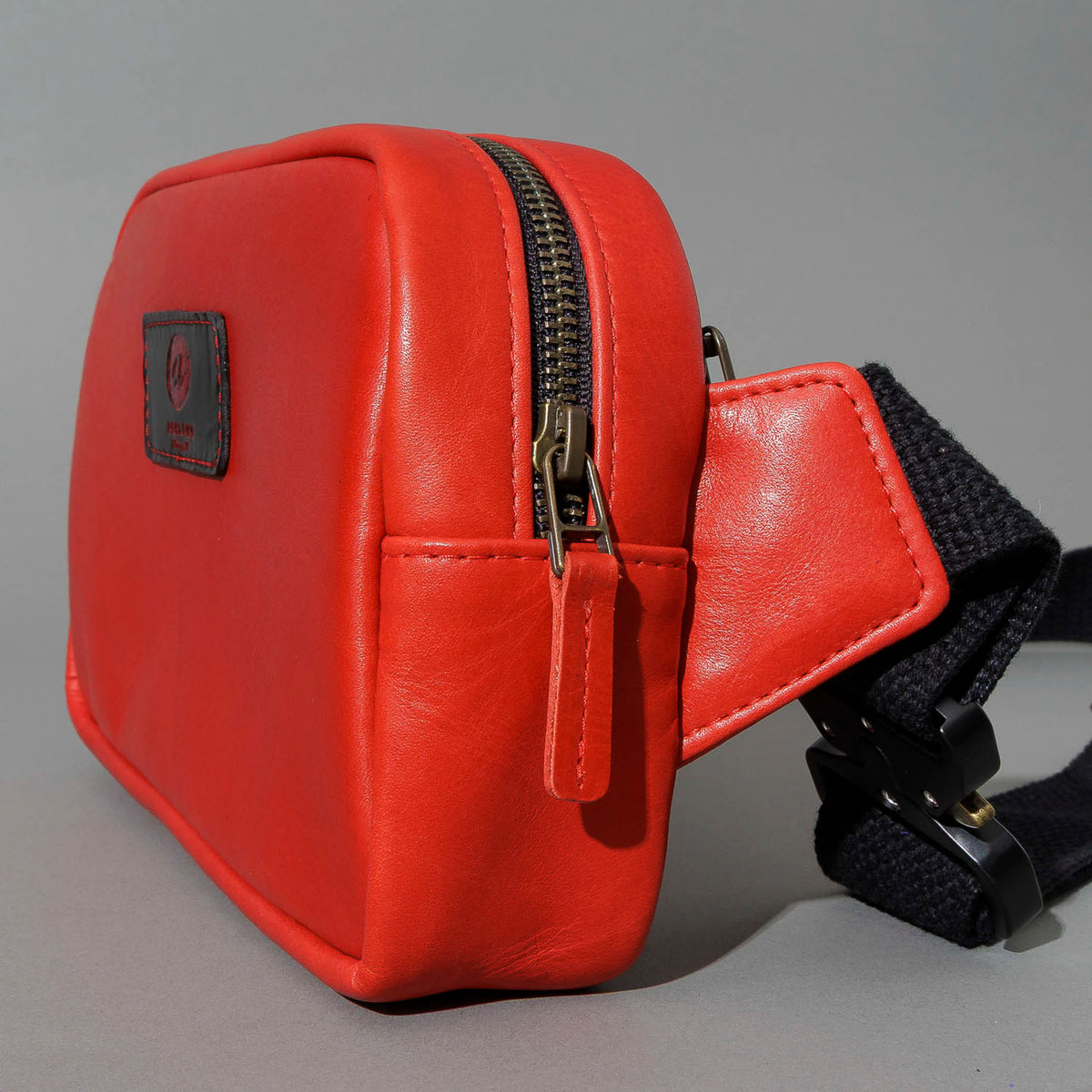 One-Off Sling Bag in Red Latigo, angled view lying flat, shot 3