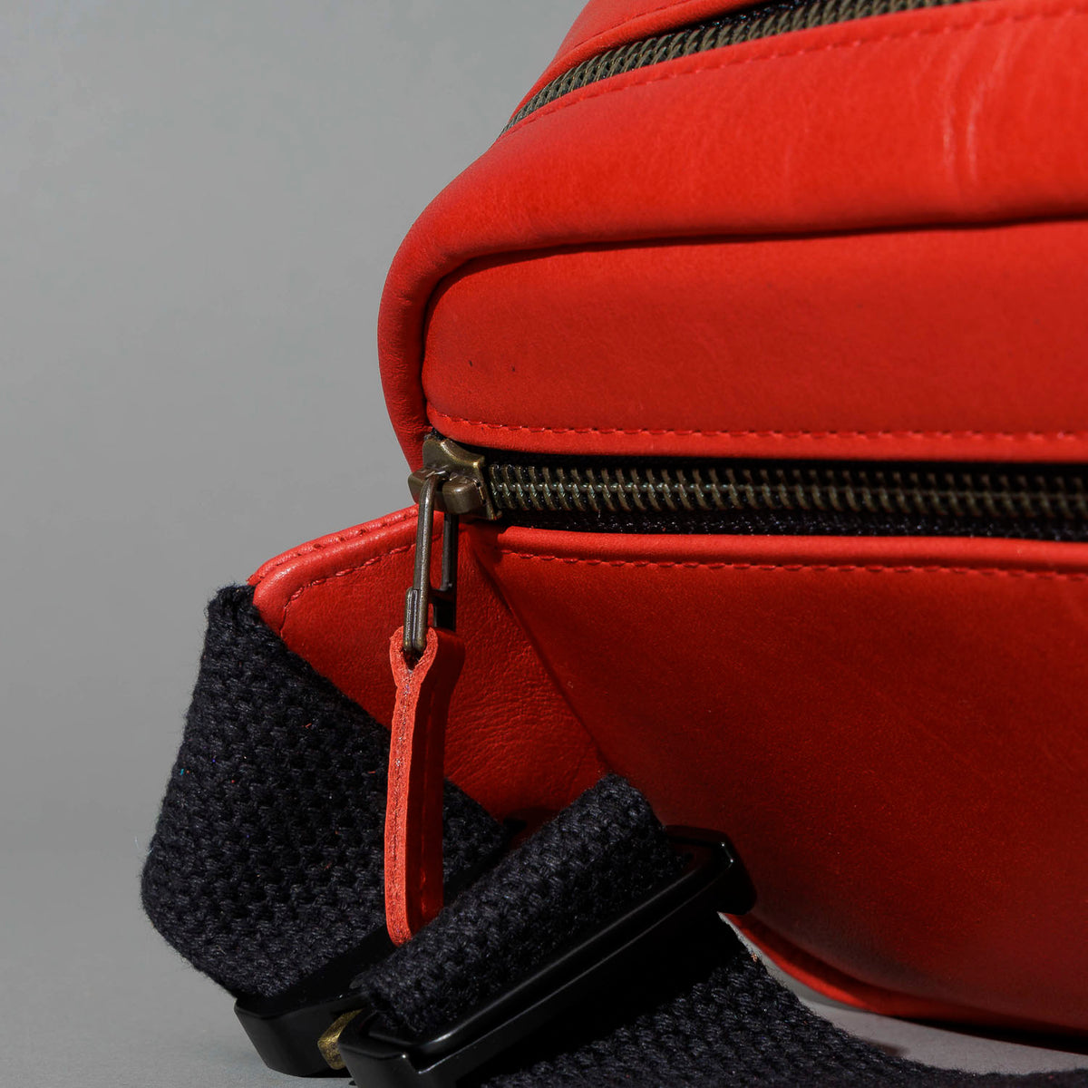 One-Off Sling Bag in Red Latigo, angled view lying flat, shot 2