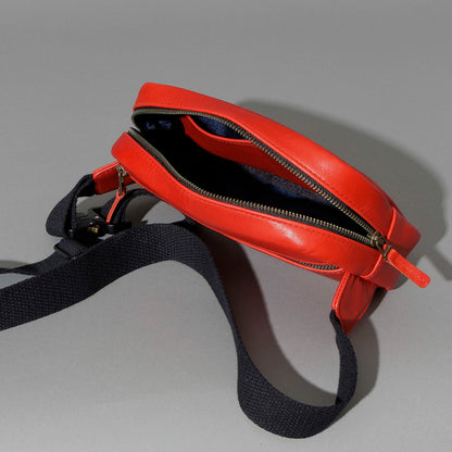 One-Off Sling Bag in Red Latigo, angled view lying flat, shot 4