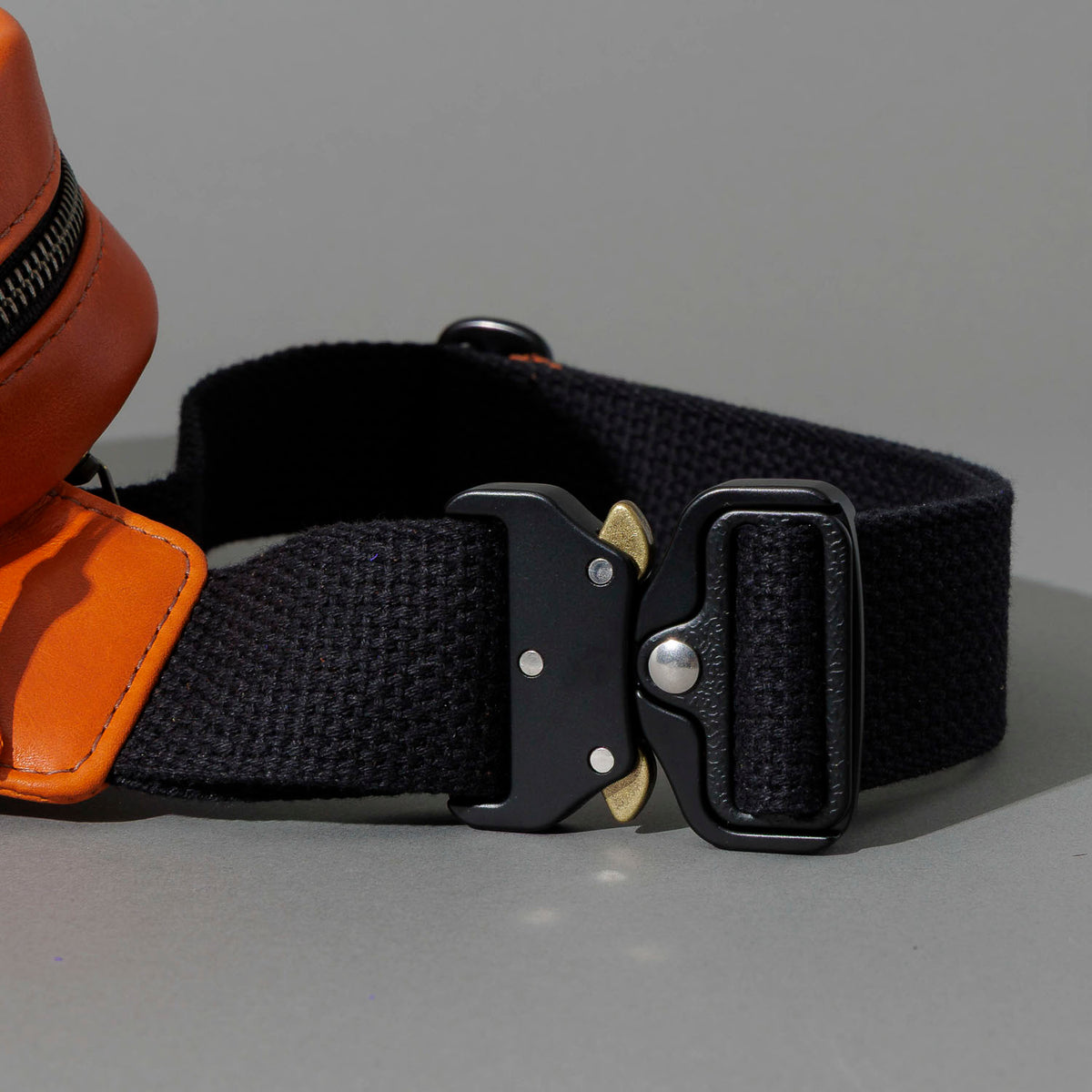 One-Off Sling Bag in Orange Latigo, close-up of the metal buckle and strap