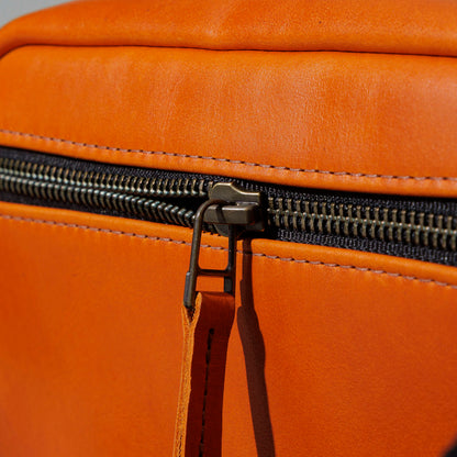 One-Off Sling Bag in Orange Latigo, close-up of the zipper, shot 2