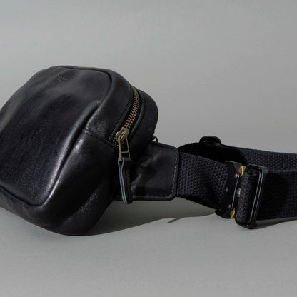 Sling Bag in Black Aspen Horsehide, angled view lying flat, shot 1