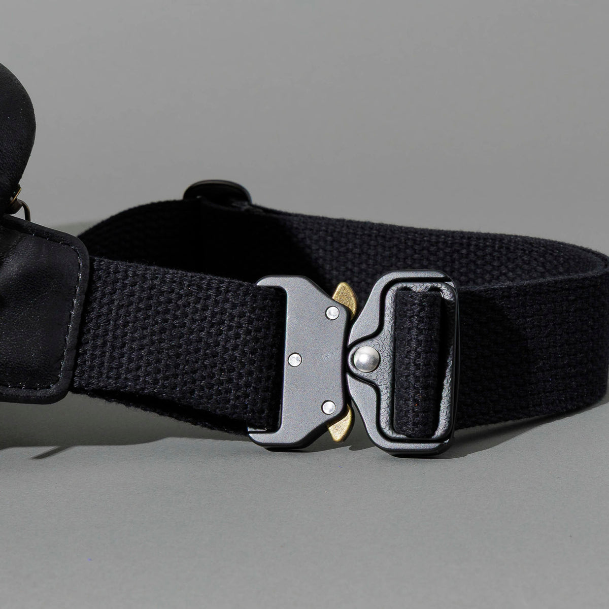 Sling Bag in Black Aspen Horsehide, close-up of the metal buckle and strap, shot 1