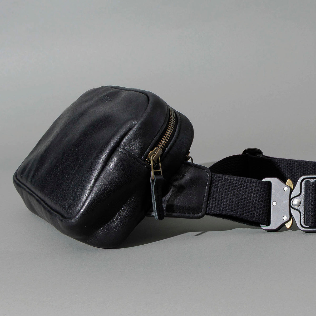 Sling Bag in Black Aspen Horsehide, angled view lying flat, shot 2
