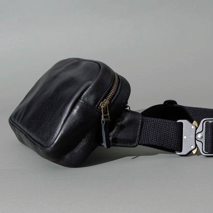 Sling Bag in Black Aspen Horsehide, angled view lying flat, shot 2