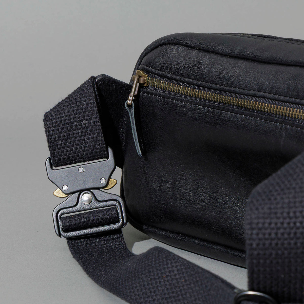 Sling Bag in Black Aspen Horsehide, close-up of the metal buckle and strap, shot 2