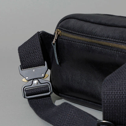 Sling Bag in Black Aspen Horsehide, close-up of the metal buckle and strap, shot 2