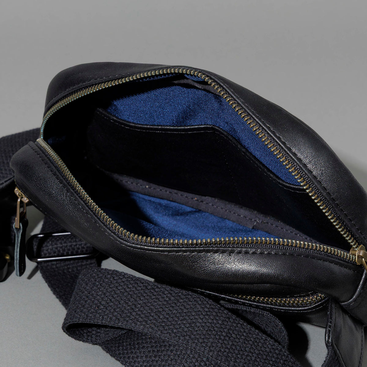 Sling Bag in Black Aspen Horsehide, unzipped, showing interior