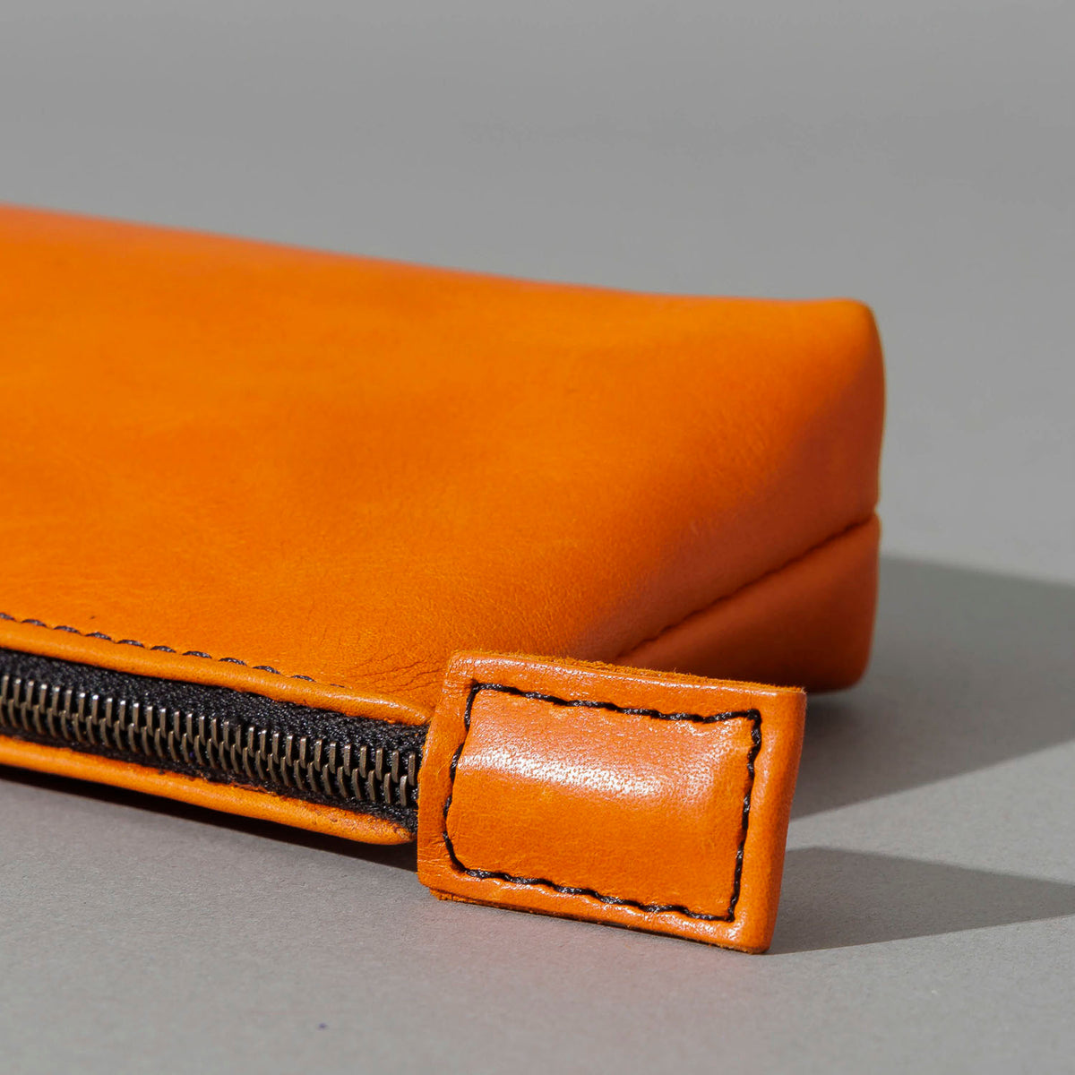 One-Off Zipper Pouch in Orange Latigo, Bat Embroidery, close-up of the zipper