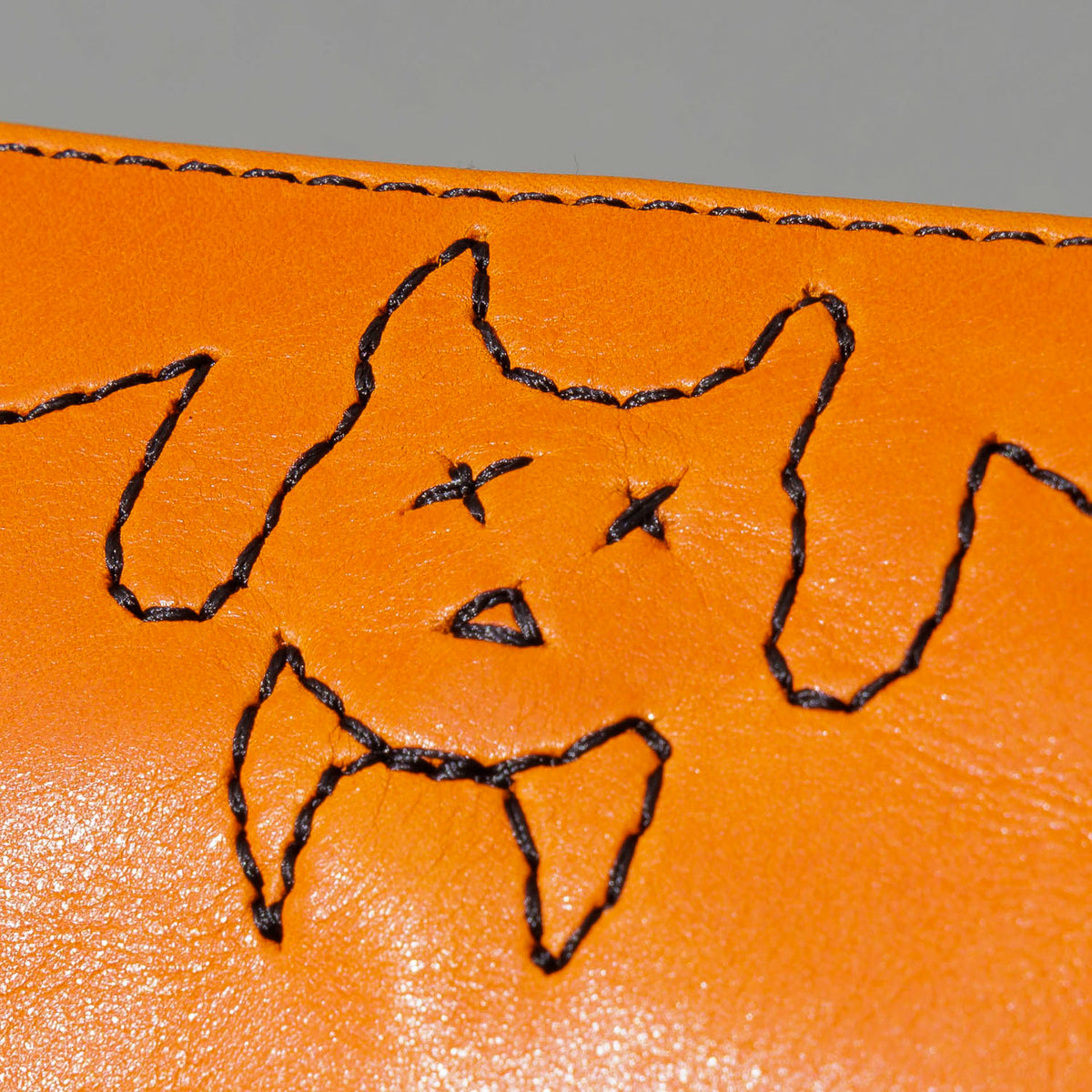 One-Off Zipper Pouch in Orange Latigo, Bat Embroidery, close-up of the embroidery, shot 2