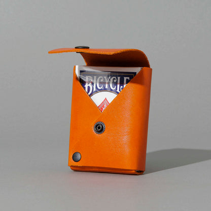 Leather Playing Card Case in Orange Latigo, open with a deck of playing cards, shot 1