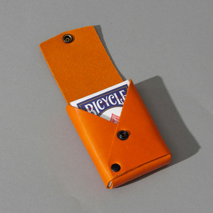 Leather Playing Card Case in Orange Latigo, open with a deck of playing cards, shot 3