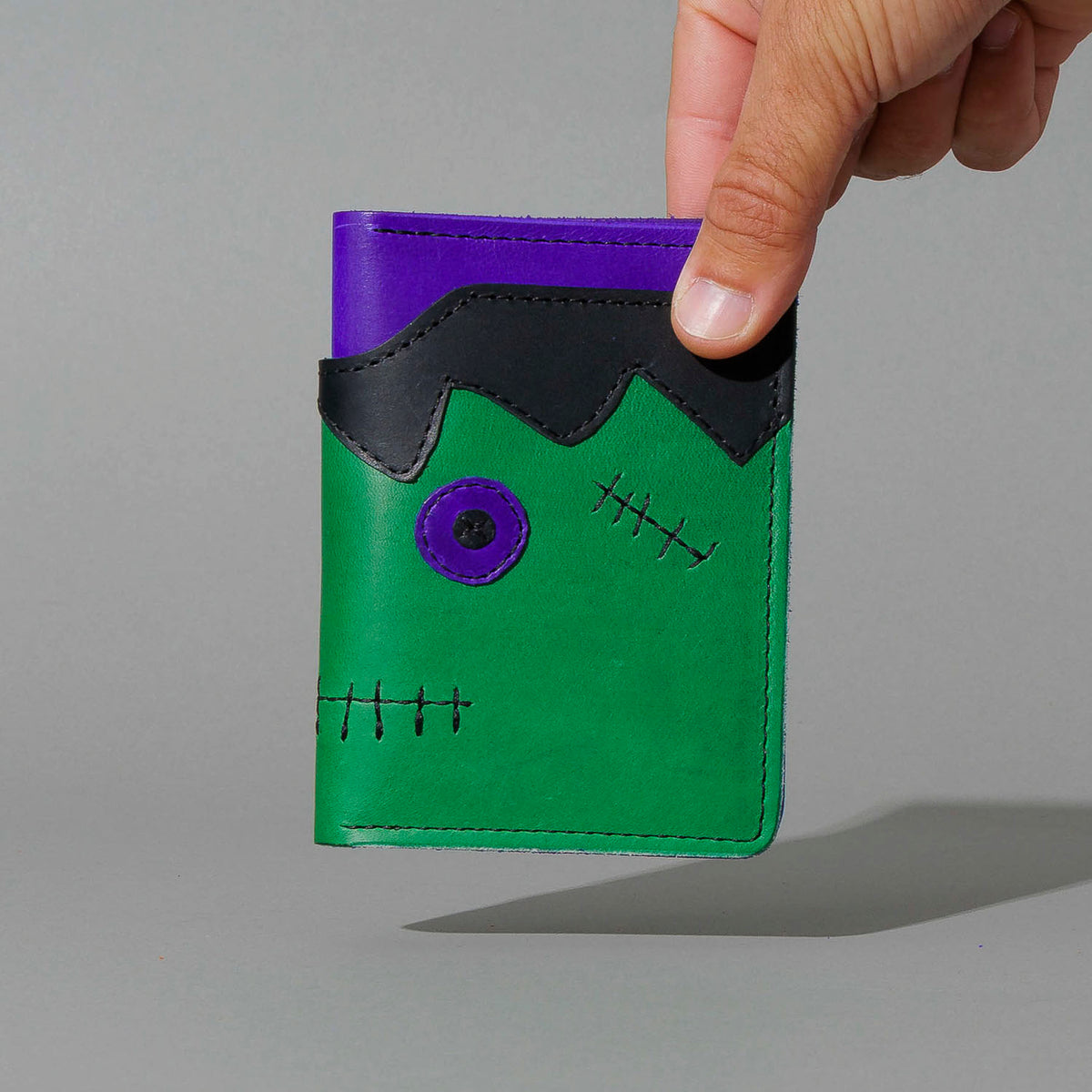 One-Off Fat Herbie in Green and Violet Latigo, Frankenstein Embroidery, held in hand, shot 1