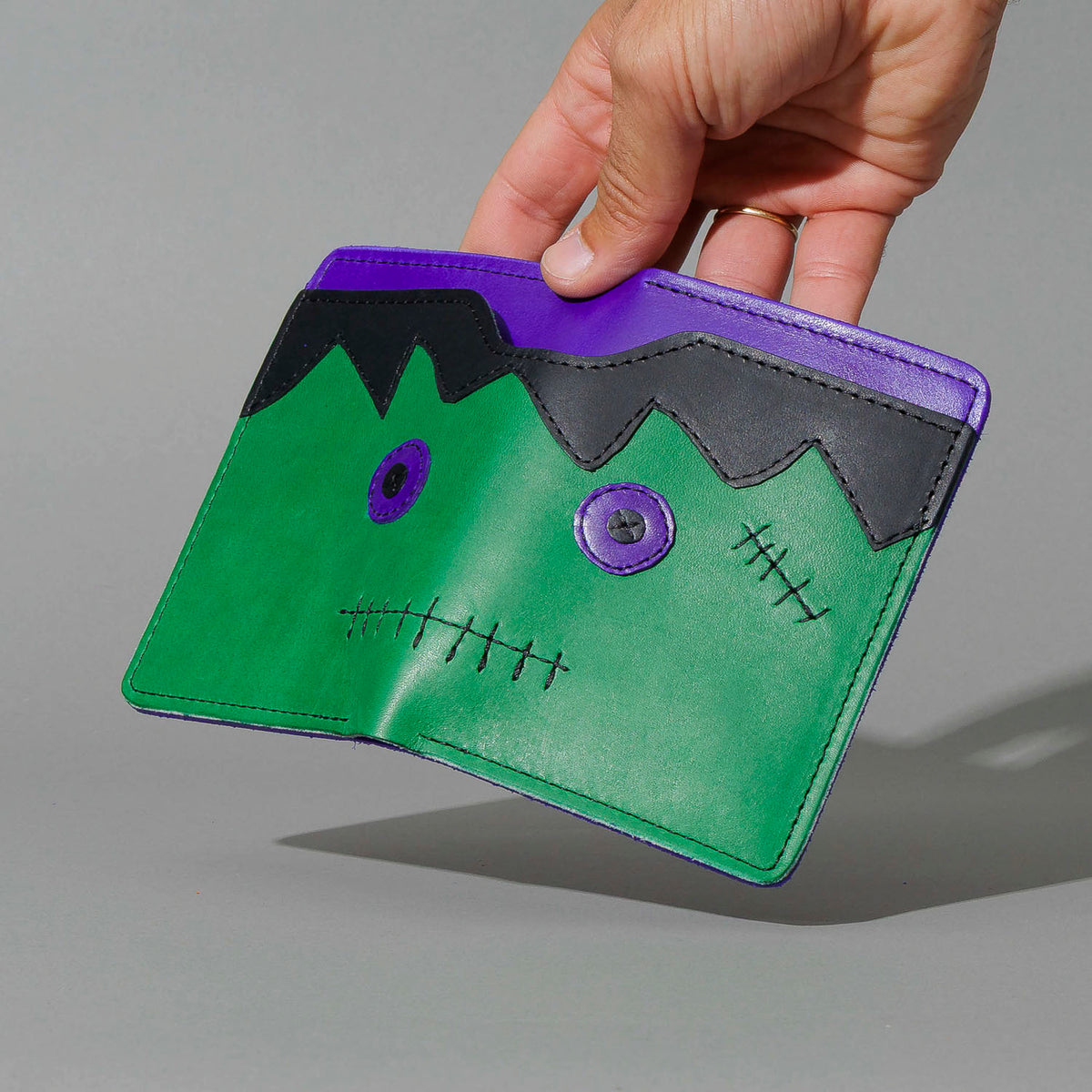 One-Off Fat Herbie in Green and Violet Latigo, Frankenstein Embroidery, held open in hand