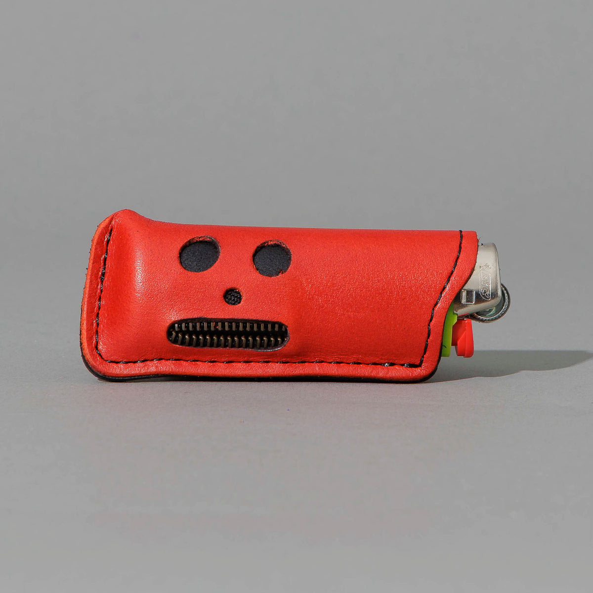 One-Off Skeleton Lighter in Red Latigo, skeleton face design, front view, shot 1