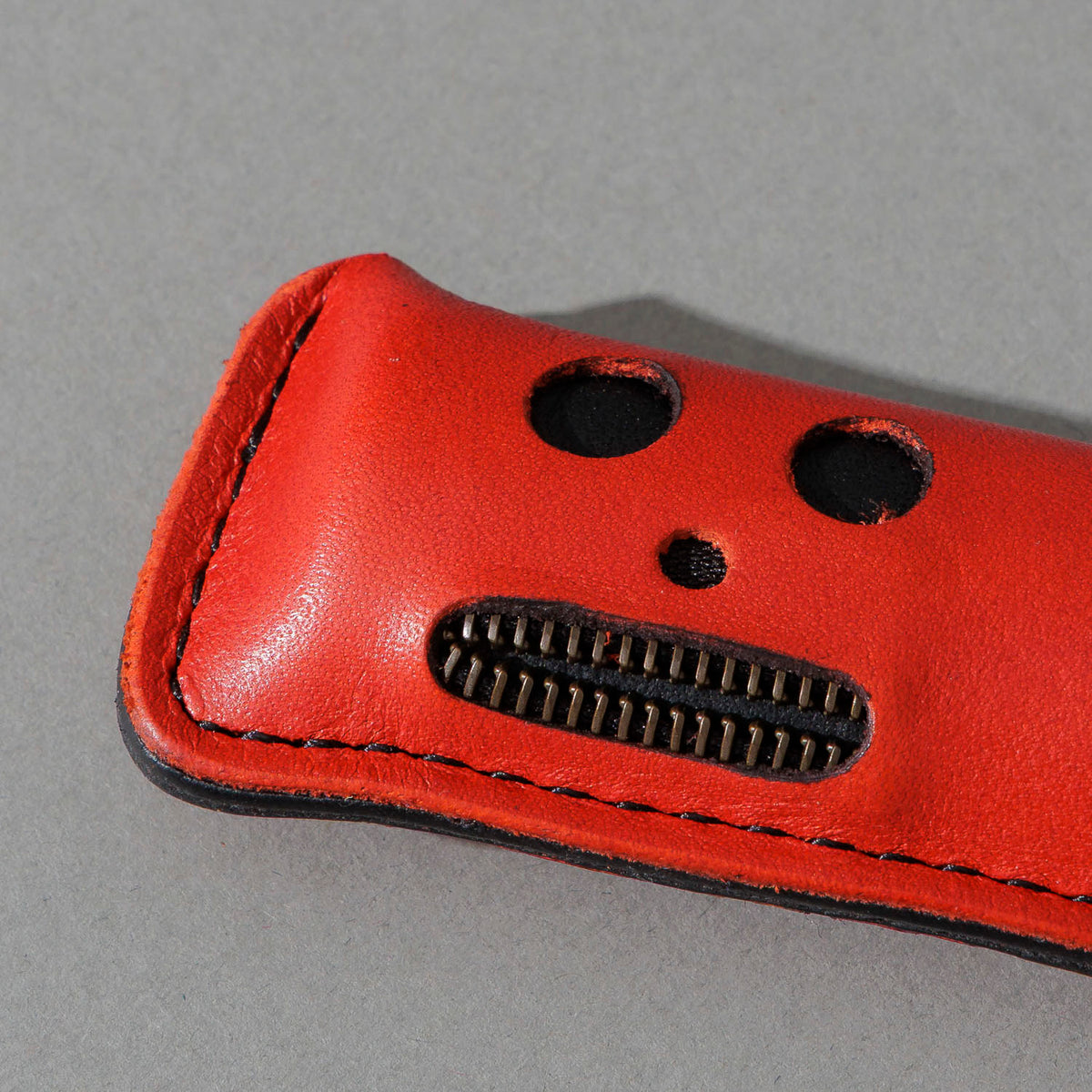 One-Off Skeleton Lighter in Red Latigo, skeleton face design, front view, shot 2