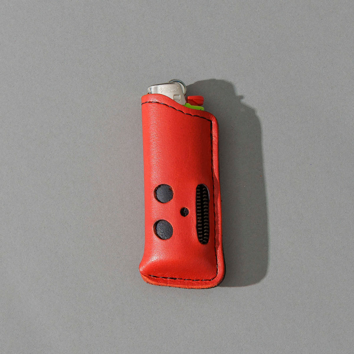 One-Off Skeleton Lighter in Red Latigo, standing upright, side angle