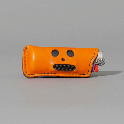 One-Off Skeleton Lighter in Orange Latigo, skeleton face design, front view, shot 1
