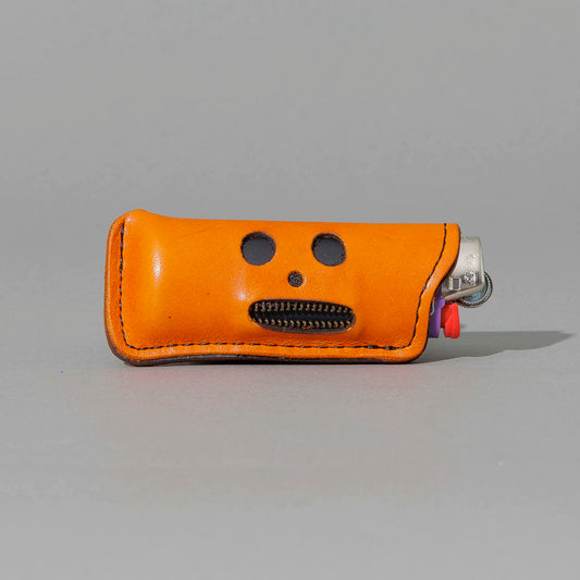 One-Off Skeleton Lighter in Orange Latigo, skeleton face design, front view, shot 1