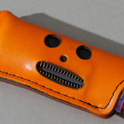 One-Off Skeleton Lighter in Orange Latigo, skeleton face design, front view, shot 3