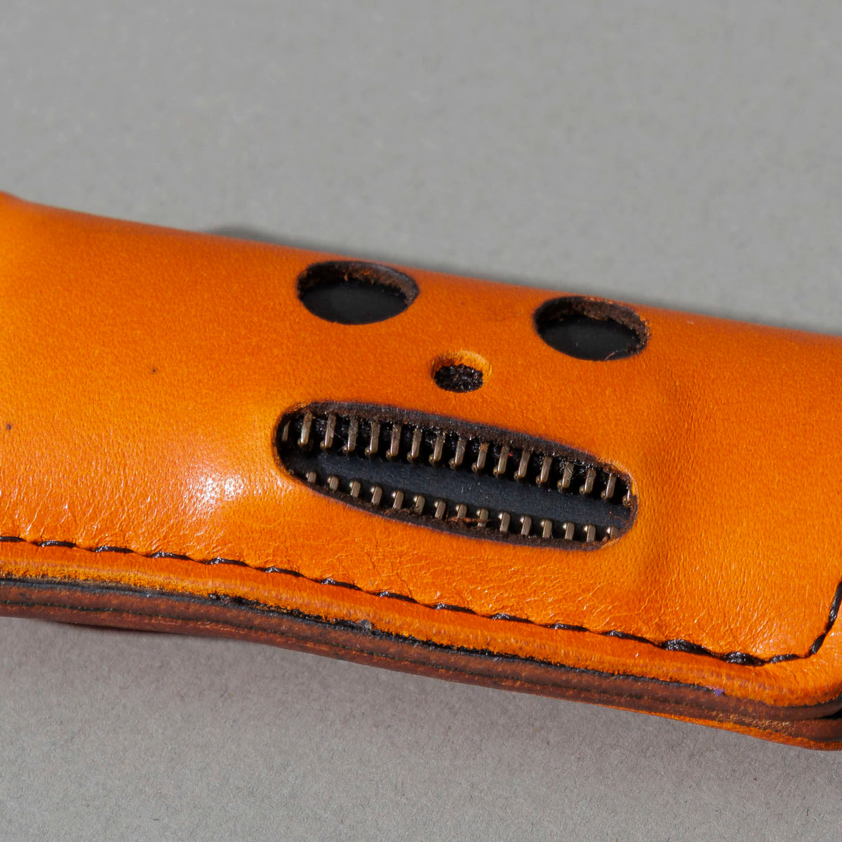 One-Off Skeleton Lighter in Orange Latigo, skeleton face design, front view, shot 4
