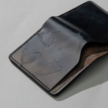 One-Off Tony the Ant in Branded Black and Reverse Shell Cordovan, Number Six Embroidery, angled view lying flat, shot 1
