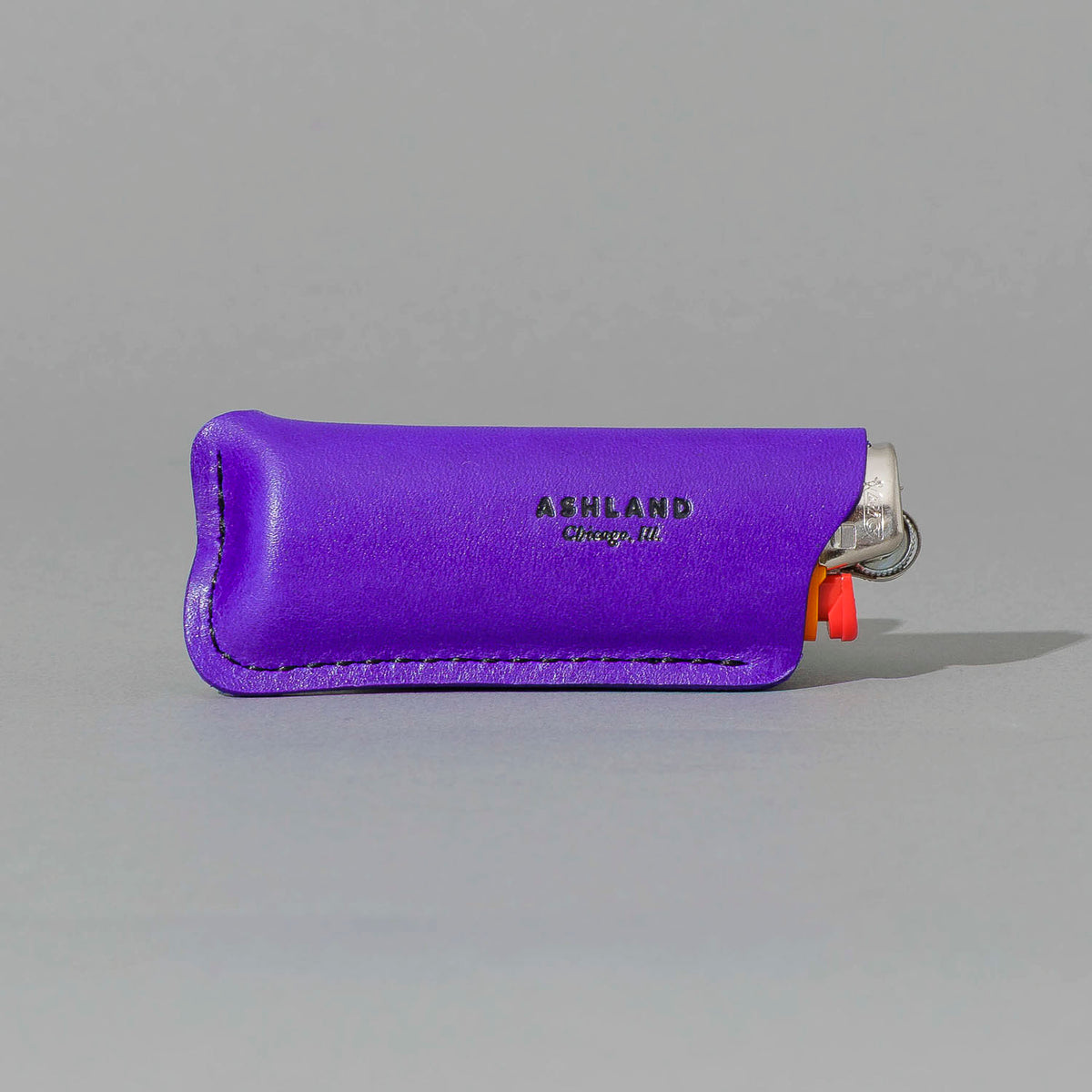 Lighter in Violet Latigo, angled view lying flat, shot 1