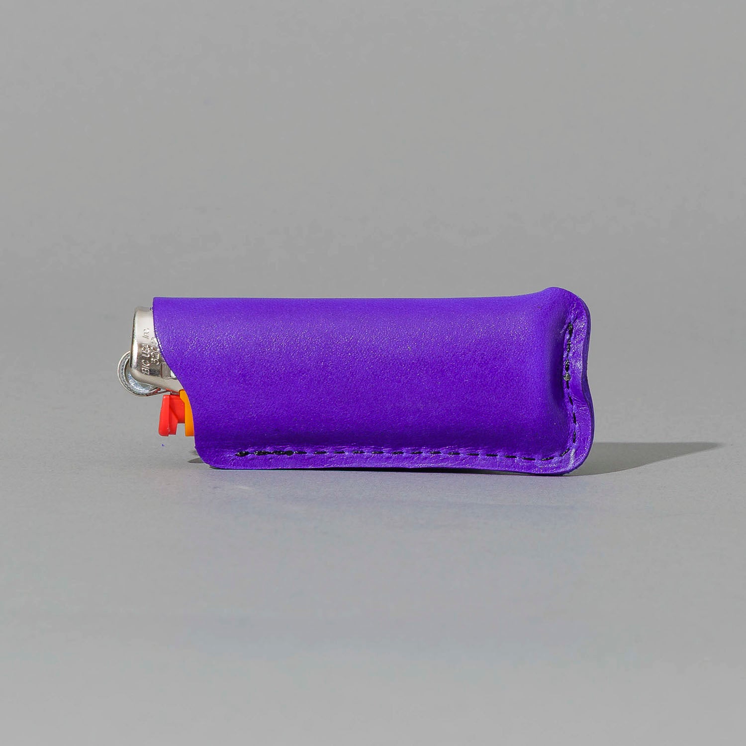 Lighter in Violet Latigo, angled view lying flat, shot 2