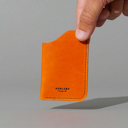 One-Shot Card Case in Orange Latigo, held in hand, shot 1