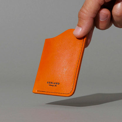 One-Shot Card Case in Orange Latigo, held in hand, shot 2