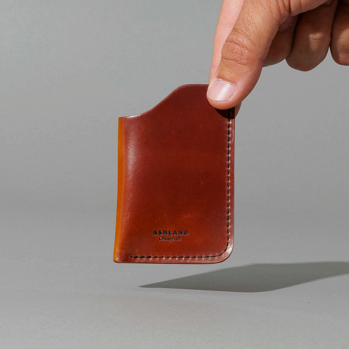 One-Off One-Shot Card Case in Blood Orange Shell Cordovan, held in hand, shot 1